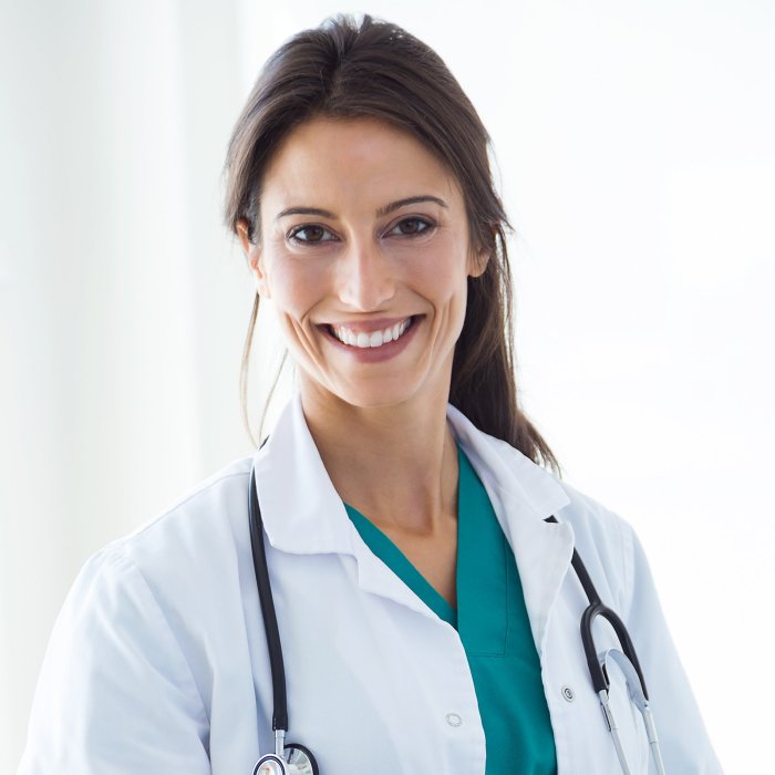 Beautiful young female doctor looking at camera in the office. | Leman ... The doctor is in your pocket how apps are harnessing musics healing powers